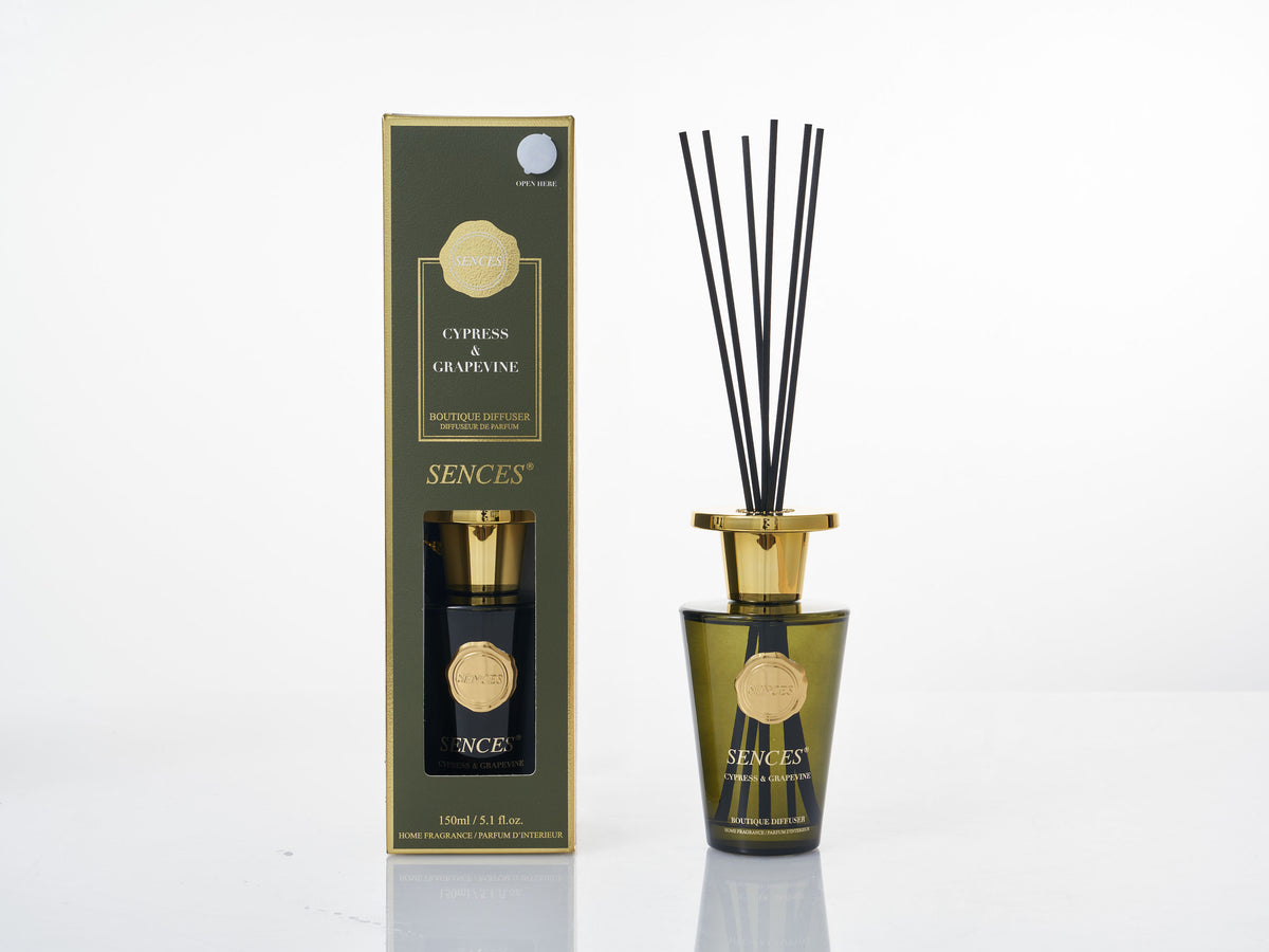 Sences Cypress & Grapevine reed diffuser in a dark green and gold box on a white background